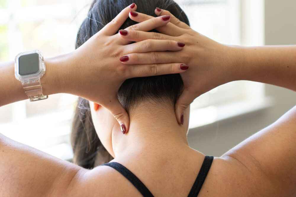 Hands demonstrating a simple neck massage technique