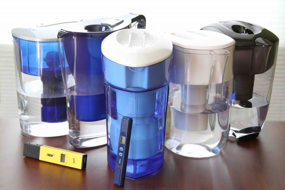 Water filter pitchers arranged with testing equipment